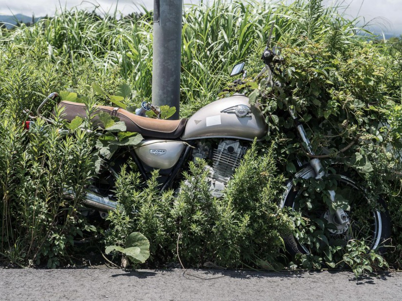 EXCLUSIVE. SPECIAL FEES APPLY . MANDATORY CREDIT: Arkadiusz Podniesinski/REX Shutterstock Mandatory Credit: Photo by Arkadiusz Podniesinski/REX Shutterstock (5224634n) A motorbike left next to a lamppost in 2011. Since the disaster weeds have grown over much of the bike's wheel. Fukushima, Japan - Sep 2015 FULL COPY: http://www.rexfeatures.com/nanolink/r7ku MINIMUM USE FEE A photographer has taken stunning and revealing pictures of the exclusion zone from the 2011 Fukushima Nuclear Disaster. Within a 20km radius the radioactive exclusion zone demonstrates the dangerous nature of nuclear energy. A network of abandoned towns and villages that once housed hundreds of thousands of people, the exclusion zone of the largest nuclear accident since Chernobyl is eerie and frightening. /EXCL_Rex_Fukushima_23/EXCLUSIVE. SPECIAL FEES APPLY . MANDATORY CREDIT: Arkadiusz Podniesinski/REX Shutterstock/1510071747